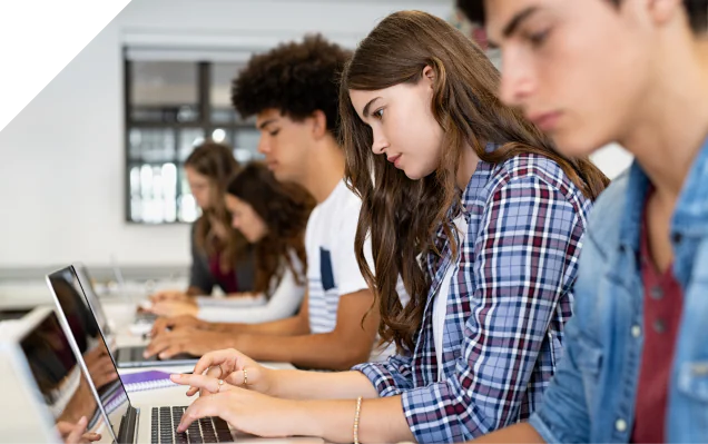 Students working on laptops in a classroom